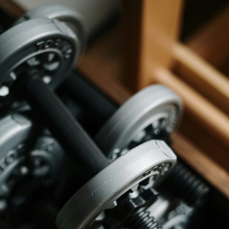 Detailed shot of dumbbells in a gym, emphasizing fitness equipment.